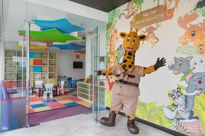a giraffe mascot standing next to a wall in a room at Marriott Executive Apartments Sukhumvit Park, Bangkok in Bangkok