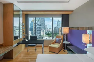 a bedroom with a bed and a desk and a chair at Renaissance Bangkok Ratchaprasong Hotel by Marriott in Bangkok