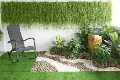 a chair sitting in a garden with plants at Le Bonheur Poshtel in Bangkok