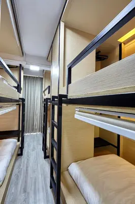 a room with four bunk beds in a room at Le Bonheur Poshtel in Bangkok