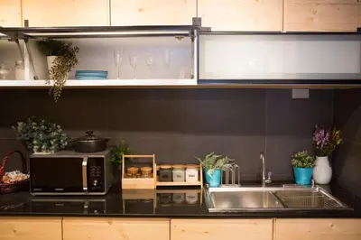 a kitchen with a sink and a microwave at PAMAhouse Boutique Hostel in Bangkok