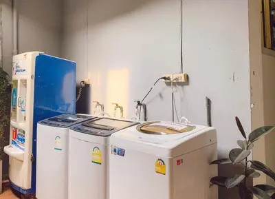 two machines sitting next to each other in a room at Pillow & Bread Hostel in Bangkok