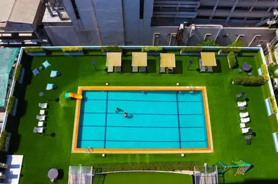 an overhead view of a large swimming pool at Evergreen Place Siam by UHG in Bangkok