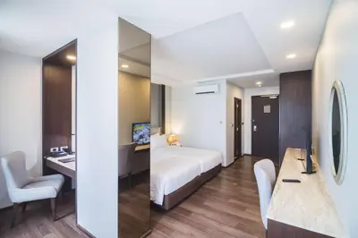 a hotel room with a bed and a desk at SureStay Plus by Best Western Sukhumvit 2 in Bangkok