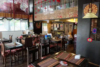 a dining room with tables and chairs in a restaurant at Sabai Sabai@Sukhumvit Hotel in Bangkok