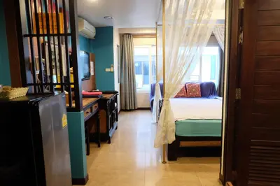 a bedroom with a bed and a window at Sabai Sabai@Sukhumvit Hotel in Bangkok