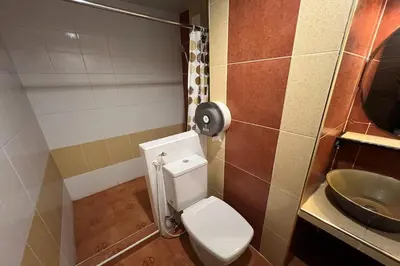 a bathroom with a toilet and a sink at Sabai Sabai@Sukhumvit Hotel in Bangkok