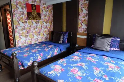 a room with two beds with blue sheets at Sabai Sabai@Sukhumvit Hotel in Bangkok