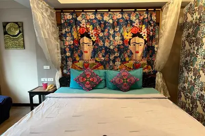 a bedroom with a bed with a painting on the wall at Sabai Sabai@Sukhumvit Hotel in Bangkok