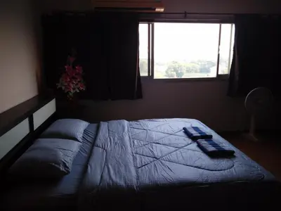 a bedroom with a large bed with a window at Renovate Room Near Impact in Ban Bang Phang