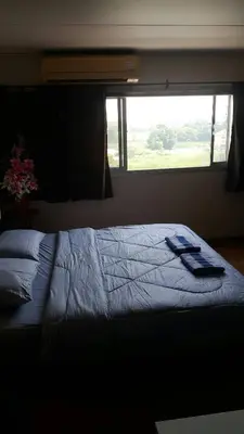 a large bed in a bedroom with a window at Renovate Room Near Impact in Ban Bang Phang