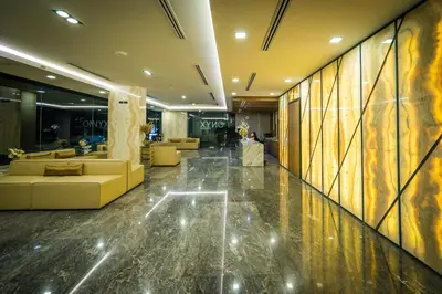 a lobby with couches and tables in a building at Onix Hotel Bangkok in Bangkok
