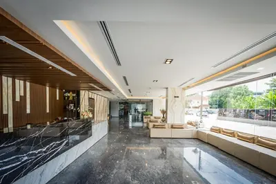 a lobby of a building with a large window at Onix Hotel Bangkok in Bangkok