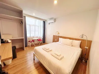 a bedroom with a bed with two towels on it at K Home Asok in Bangkok