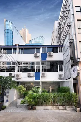 a white building with plants in front of it at K Home Asok in Bangkok