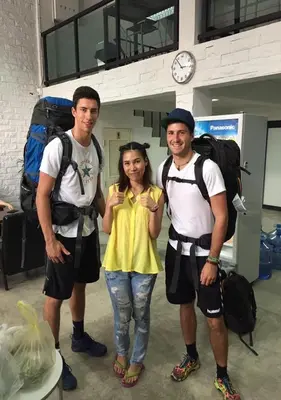a group of three people posing for a picture at Backpack Station in Bangkok