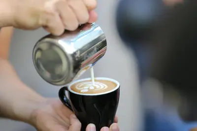 a person is holding a cup of coffee at Baan 2459 Heritage House in Bangkok