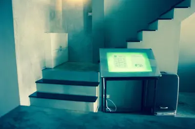 a room with a desk with a box and stairs at Home'81 in Bangkok