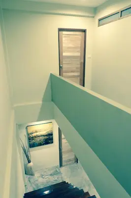 a staircase in a house with a blue wall at Home'81 in Bangkok