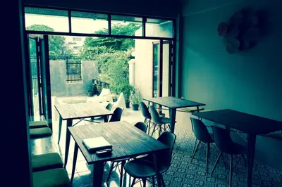 a row of tables and chairs in a restaurant at Home'81 in Bangkok