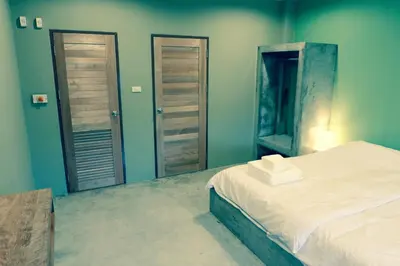 a bedroom with a bed and a mirror at Home'81 in Bangkok