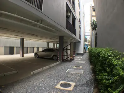 a car parked in a parking lot next to a building at 28 Place in Bangkok