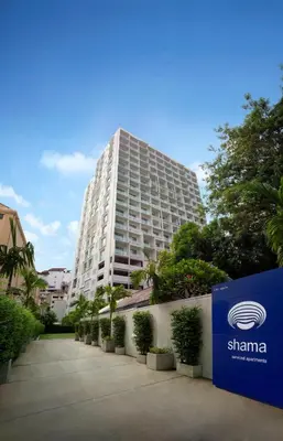 a tall building with a sign in front of it at Shama Sukhumvit Bangkok in Bangkok