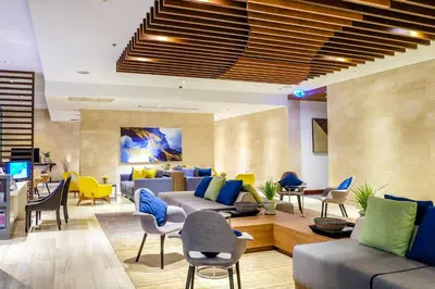 a lobby with couches and tables and chairs at Shama Sukhumvit Bangkok in Bangkok