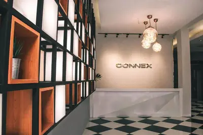 a lobby with a sign on the wall and a checkered floor at The Connex Asoke in Bangkok