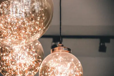 a cluster of lights hanging from a ceiling at The Connex Asoke in Bangkok