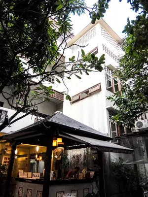 a restaurant with an awning in front of a building at Lamphuhouse Bangkok in Bangkok