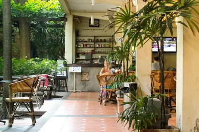 a person sitting at a table in a restaurant at Lamphuhouse Bangkok in Bangkok