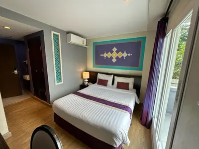 a bedroom with a large bed in a room at Sawasdee Hotel @ Sukhumvit Soi 8 in Bangkok