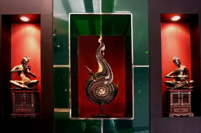 a glass box with a snake on display in a bathroom at Mirth Sathorn Hotel in Bangkok