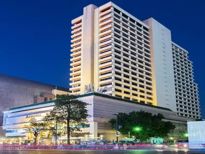 a large building in front of a building at night at Arnoma Hotel Bangkok in Bangkok