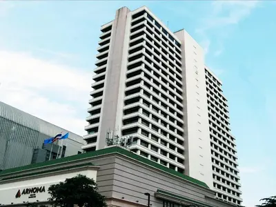 a tall white building with a building at Arnoma Hotel Bangkok in Bangkok