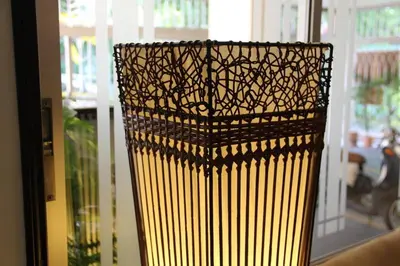 a yellow vase sitting in front of a window at B.S. Court Hotel Sathorn in Bangkok