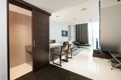 a room with a kitchen and a living room at S31 Sukhumvit Hotel in Bangkok