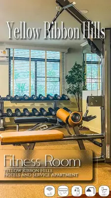 a gym with a yellow ribbon room with a fitness room with a mirror at Yellow Ribbon Hills Boutique Suites in Bangkok