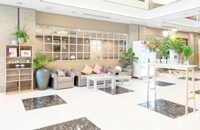 a lobby of a store with couches and plants at Yellow Ribbon Hills Boutique Suites in Bangkok