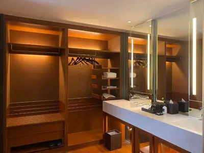 a bathroom with two sinks and a large mirror at Hansar Bangkok Hotel in Bangkok