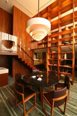 a dining room with a table and chairs at Hansar Bangkok Hotel in Bangkok