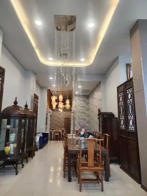 a dining room with a table and chairs and a chandelier at August Residence in Bangkok