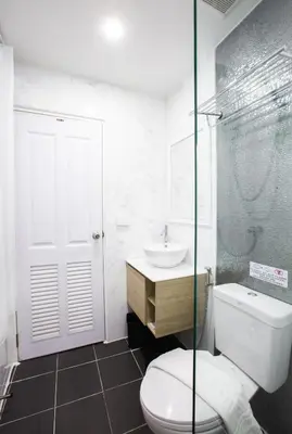 a bathroom with a toilet and a sink at House of Happiness in Bangkok