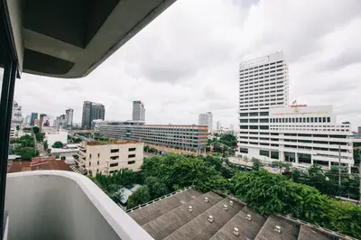 a view of the city from the balcony of a building at Baan Pratoom in Bangkok