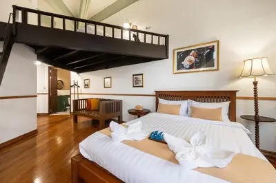 a bedroom with a large bed with a loft at Arun Sa Wad 103 NaNa in Bangkok