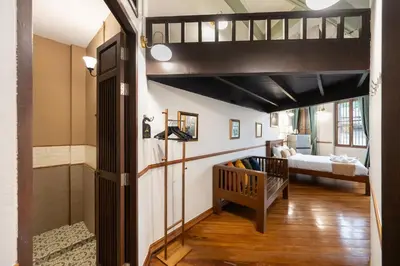a room with a loft bed and a crib at Arun Sa Wad 103 NaNa in Bangkok