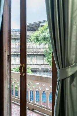 a window with a view of a building at Arun Sa Wad 103 NaNa in Bangkok