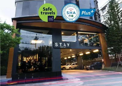 a store front with a sign that says skip travels skip plus at STAY Hotel BKK in Bangkok