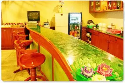 a kitchen with a table with flowers on it at Wall Street Inn, Bangkok in Bangkok